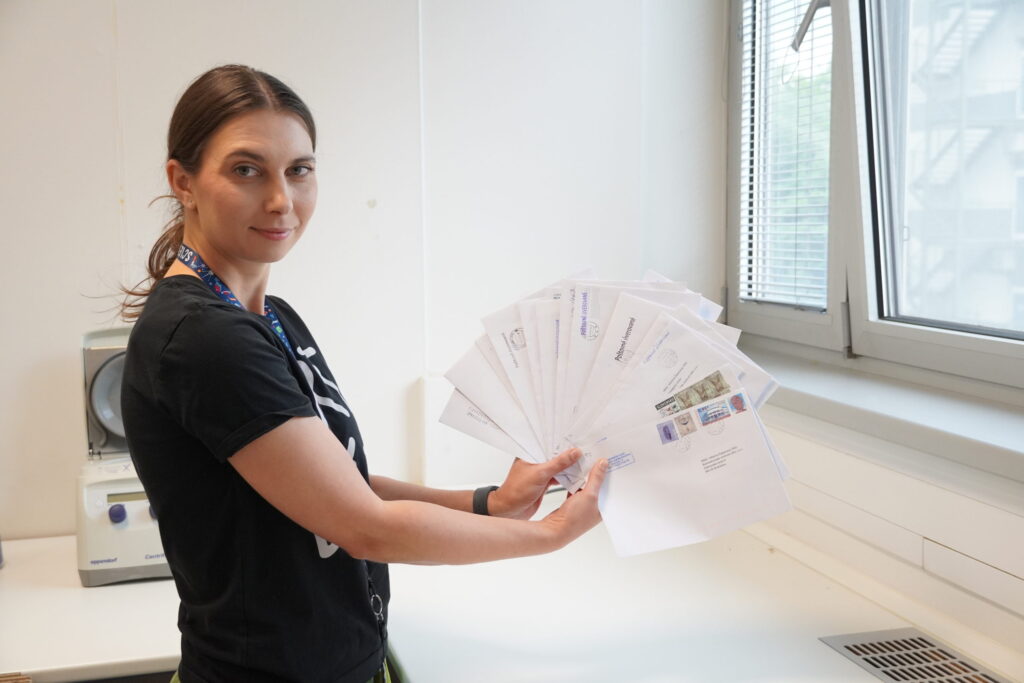 Dr. Viktória Čabanová with envelopes containing cards with mosquito saliva samples from regional public health authorities.