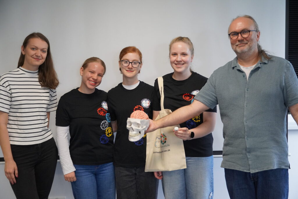 Vedúci Laboratória pre komplexný výskum mozgu a sluchu Dr. Peter Hubka (vpravo) s účastníčkami Letnej školy mladých vedcov.